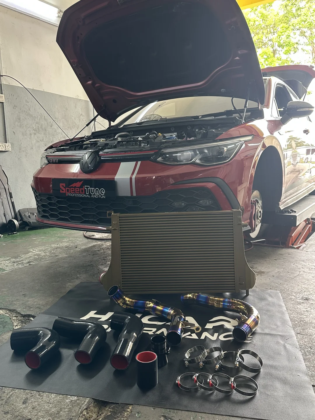 The GTI MK8 in the shop with the intercooler and titanium pipes laid out