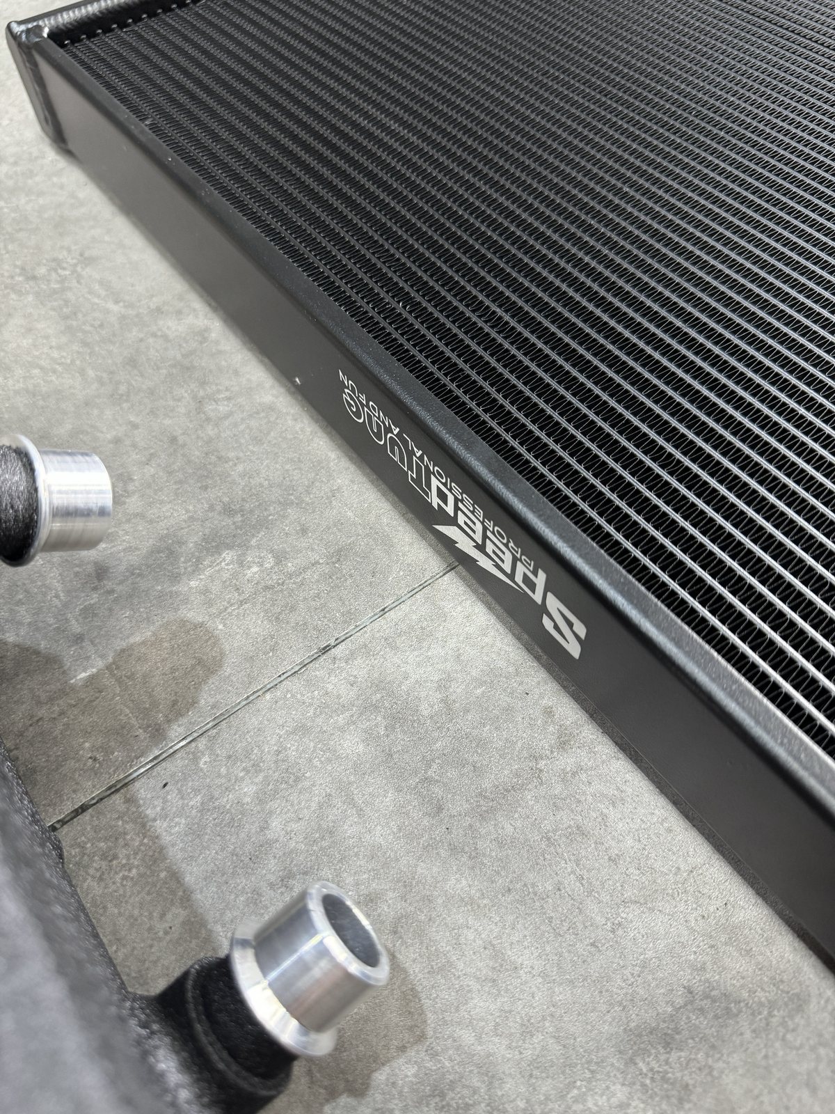 S55 charge cooler radiator in black — close-up